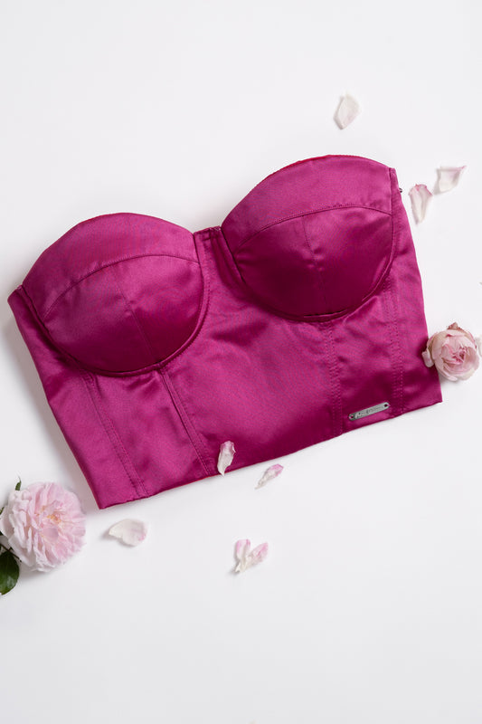 Bustino fucsia satinato con fiori sullo sfondo